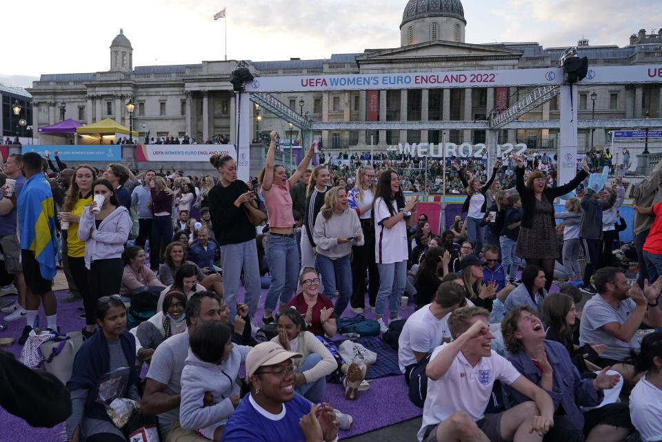 FILE - England supporters celebrate after Beth Mead scored the opening goal as they watch a live screening of the Women's Euro 2022 semifinal soccer match between England and Sweden at the fan area in Trafalgar Square in London, England, Tuesday, July 26, 2022. The march to Sunday's final against Germany has energized people throughout England, with the team's pinpoint passing and flashy goals attracting record crowds, burgeoning TV ratings and adoring coverage. The Lionesses, as the team is known, have been a welcome distraction from the political turmoil and cost-of-living crisis that dominate the headlines. (AP Photo/Albert Pezzali, File)