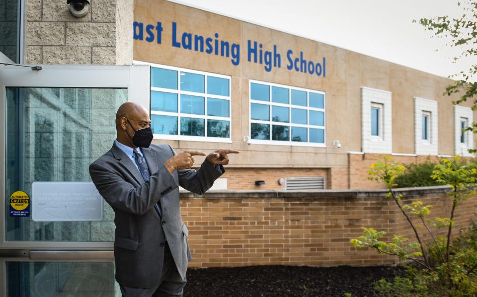 East Lansing High School Principal Andrew Wells welcomes students Thursday morning, May 19, 2022. After 33 years in education, Wells will retire at the end of the academic year. Each morning he greets and acknowledges every student at the entrance.