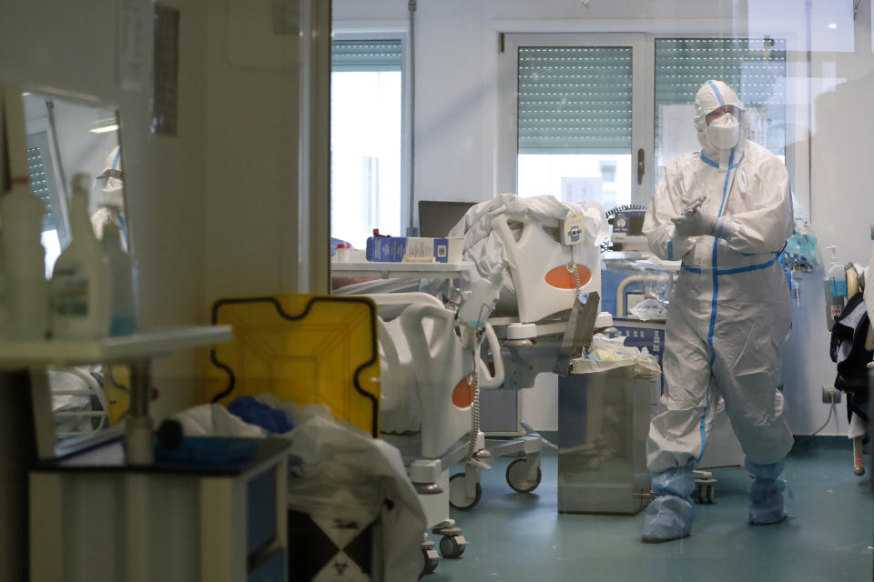 A healthcare worker disinfects his hands inside a COVID-19 Intensive Care Unit at the military hospital in Lisbon, Wednesday, Jan. 27, 2021. The military hospital is expanding it's number of beds available to take COVID-19 patients from the National Health Service. Portugal is reporting new daily records of COVID-19 deaths and hospitalizations as a recent pandemic surge continues unabated. (AP Photo/Armando Franca)