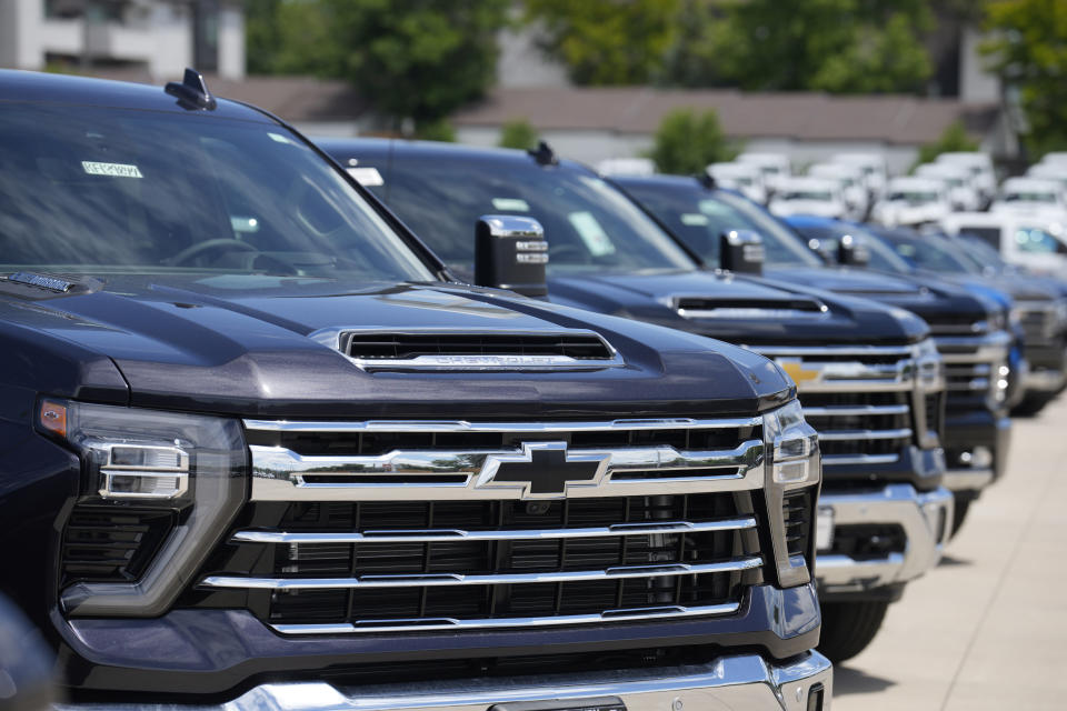 File - Unsold 2023 Silverado pickup trucks sit in a long row at a Chevrolet dealership June 18, 2023, in Englewood, Colo. General Motors reports earning on Jan. 30, 2024. (AP Photo/David Zalubowski, File)