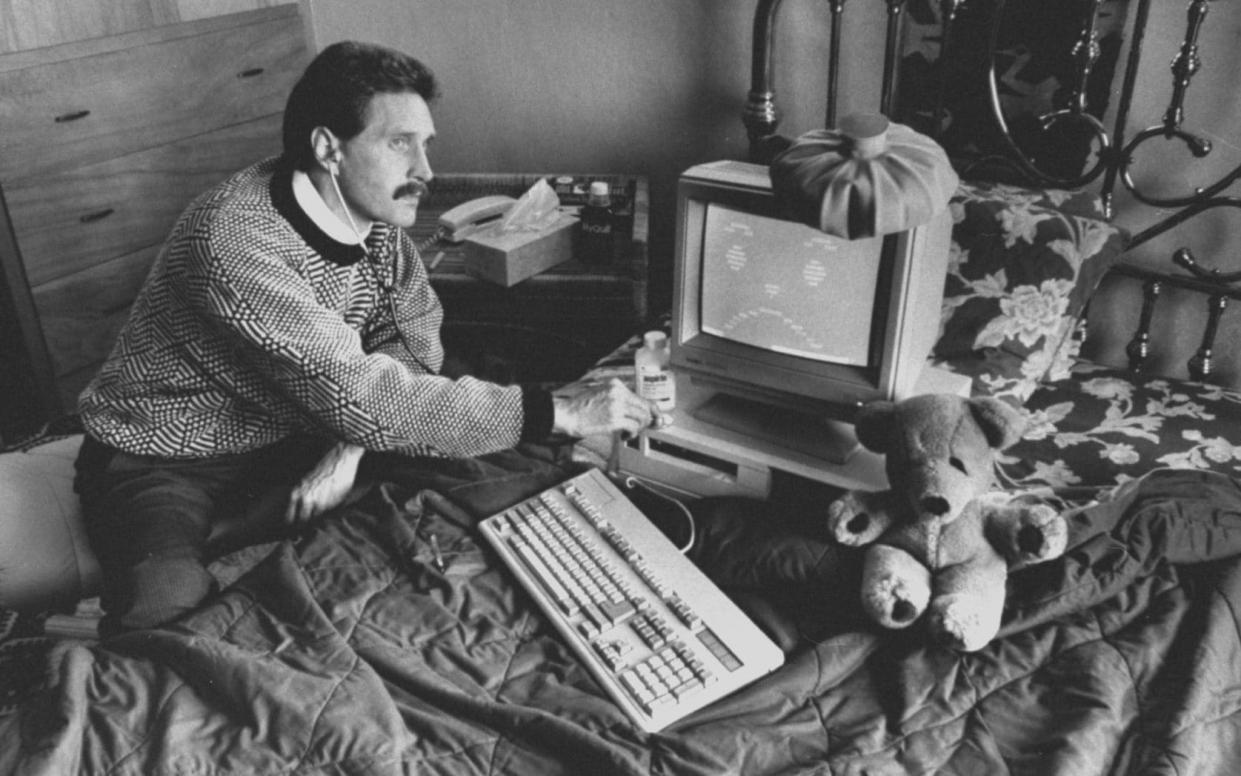McAfee circa 1989 holding a stethoscope to a computer with an ice bag on top of it, illustrating the computer virus which he was able to eradicate at home - John Storey/Getty Images
