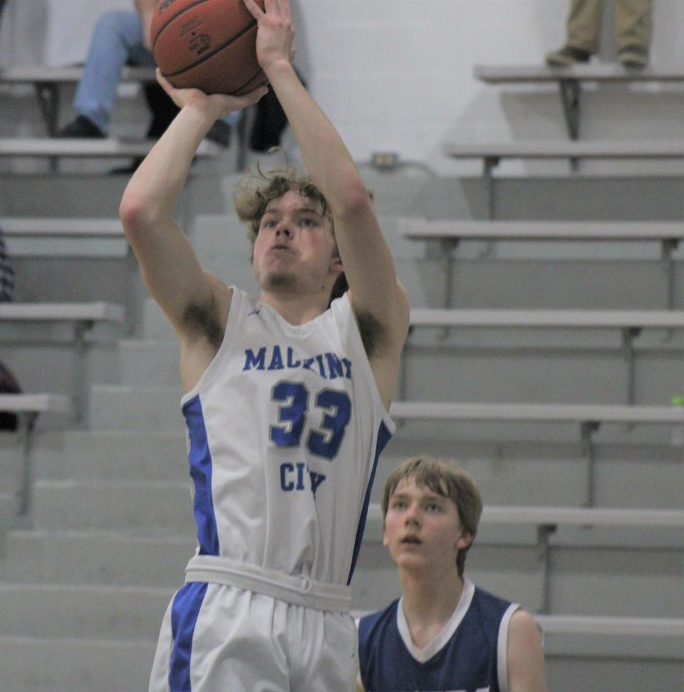 Mackinaw City senior Trystan Swanson (33) made the All-NLC boys basketball first team after a terrific final season with the Comets.