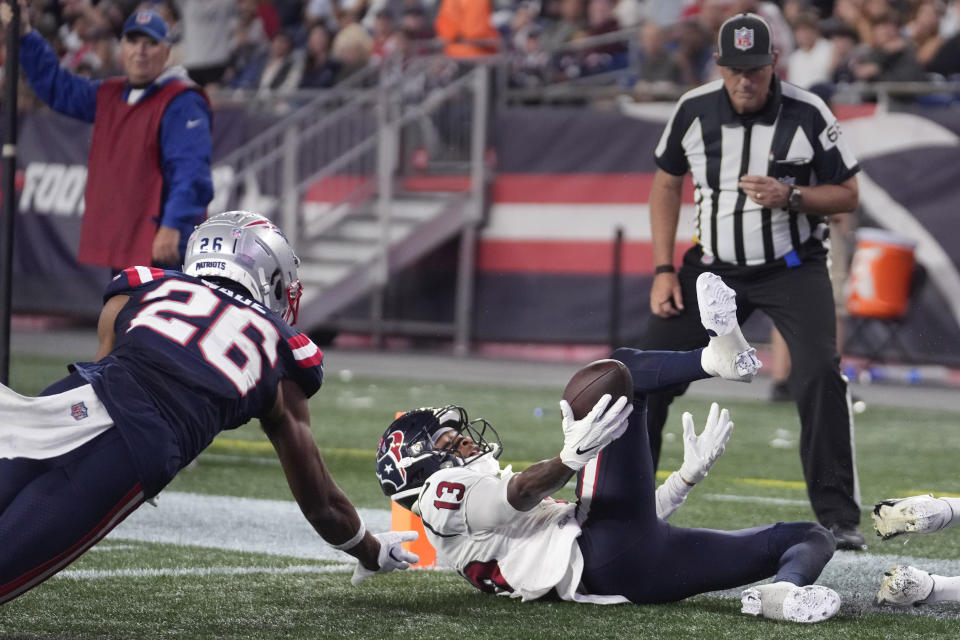 Houston Texans wide receiver Tank Dell (13) recovers the ball, after losing his grip, for a touchdown next to New England Patriots cornerback Shaun Wade (26) during the first half of an NFL preseason football game Thursday, Aug. 10, 2023, in Foxborough, Mass. (AP Photo/Steven Senne)