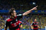 Germany's forward Miroslav Klose celebrates after scoring during the semi-final football match between Brazil and Germany at The Mineirao Stadium in Belo Horizonte during the 2014 FIFA World Cup on July 8, 2014