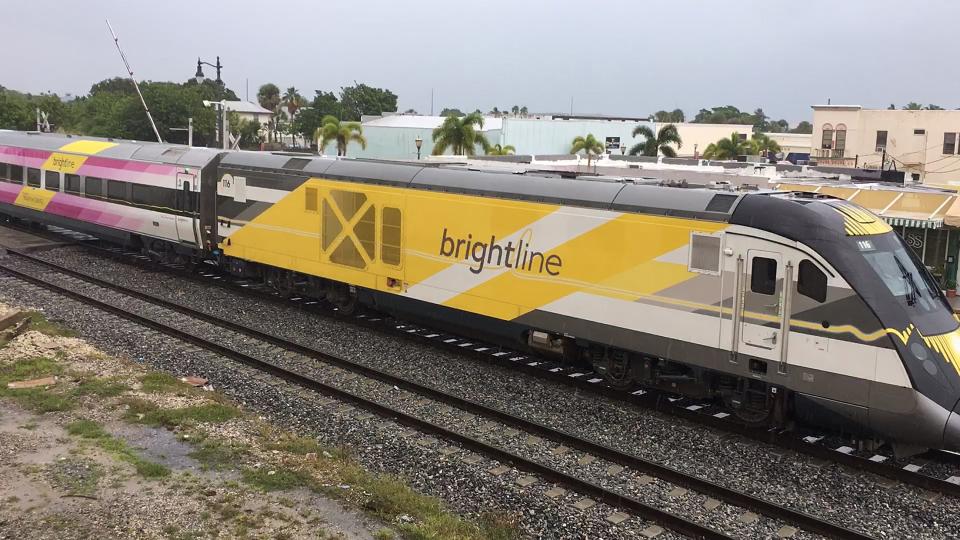 In this screen image from video, a Brightline train #116 that was stopped at Avenue A (southbound) with the crossing arms up, then passed the intersection and the crossing arm started to come down on Wednesday, Sept. 19, 2023, in Fort Pierce.