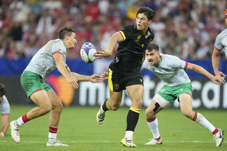 FILE - Wales' Louis Rees-Zammit, center, passes the ball during the Rugby World Cup Pool C match between Wales and Portugal in the Stade de Nice, in Nice, France, Sept. 16, 2023. Rees-Zammit, whose favorite NFL player growing up was three-time Pro Bowl wide receiver DeSean Jackson, is one of 16 athletes from eight countries participating in the NFL International Player Pathway program. It was established in 2017 to provide elite athletes from around the world the opportunity to earn a spot on an NFL roster and increase the number of international players in the league. (AP Photo/Pavel Golovkin, File)