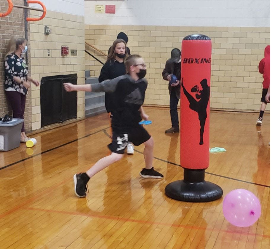 In this file photo, Mental health experts offer a kickboxing station for Neponset Grade School students to relieve stress during a recent day devoted to developing coping skills.