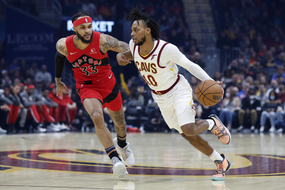 Cleveland Cavaliers' Darius Garland (10) drives against Toronto Raptors' Gary Trent Jr. (33) during the first half of an NBA basketball game, Sunday, March 6, 2022, in Cleveland. (AP Photo/Ron Schwane)