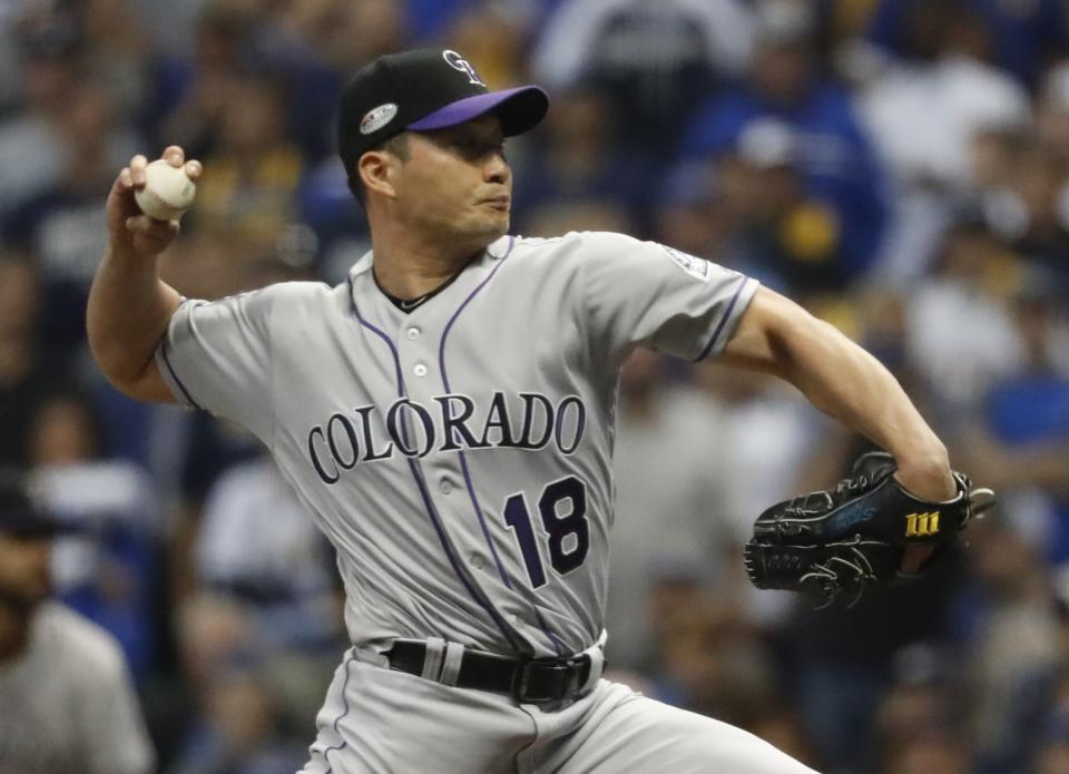 Colorado Rockies relief pitcher Seunghwan Oh throws during the eighth inning of Game 2 of the National League Divisional Series baseball game against the Milwaukee Brewers Friday, Oct. 5, 2018, in Milwaukee. (AP Photo/Jeff Roberson)