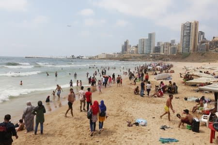 People swim at Ramlet al-Bayda public beach in Beirut