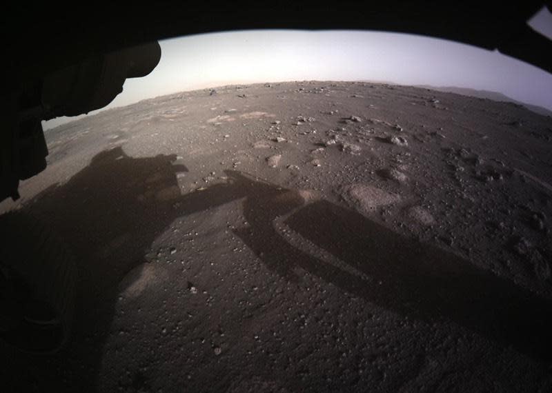 The first color image from Perseverance comes from a hazard-avoidance camera, or hazcam, on the front of the rover showing the relatively clear ground ahead. / Credit: NASA/JPL-Caltech