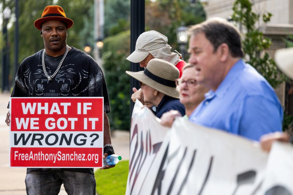 Paris Powell, a death row survivor, gathers with anti-death penalty activists Thursday morning at the Governor's Mansion ahead of the execution of Anthony Sanchez, who was convicted in 2006 of first-degree murder in the shooting death of Juli Busken, a 21-year-old dance student.