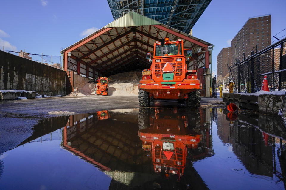 New York City Sanitation Department front-end Loaders wait to to fill a salt spreaders at one of the department's salt sheds in lower Manhattan, Friday, Jan. 7, 2022, in New York. A winter storm that has already left areas of the south with more than 6 inches of snow moved into the northeast during the morning commute and prompted many school districts to close for the day. (AP Photo/Mary Altaffer)