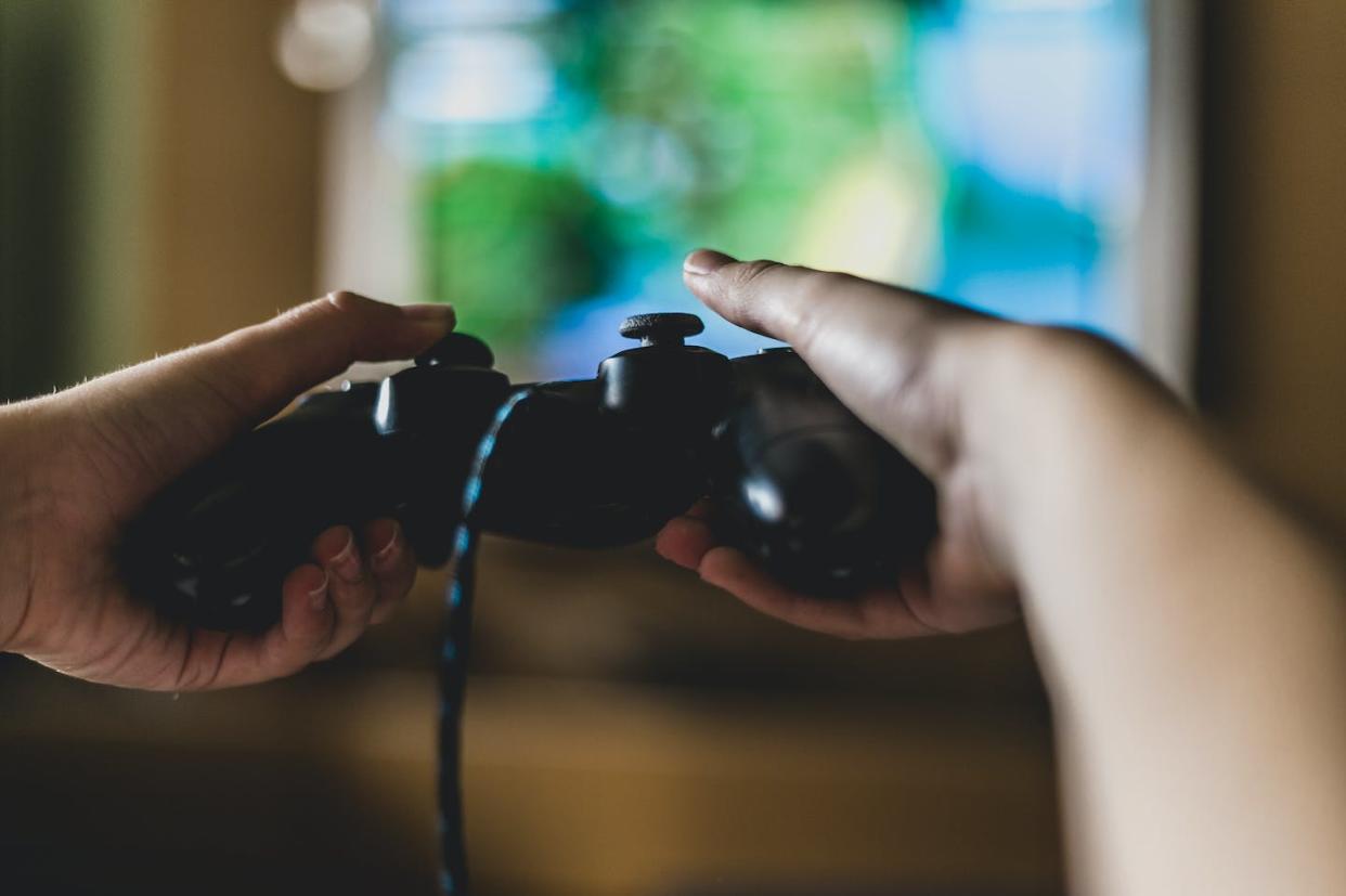 In addition to being fun, video games can build real-world skills. <a href="https://www.gettyimages.com/detail/photo/close-up-of-boy-holding-game-controller-royalty-free-image/1182425001" rel="nofollow noopener" target="_blank" data-ylk="slk:Carol Yepes/Moment via Getty images;elm:context_link;itc:0;sec:content-canvas" class="link ">Carol Yepes/Moment via Getty images</a>