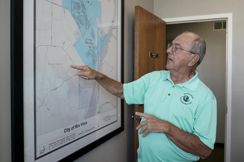 Mayor Ron Kott looks over a map of rural Solano County at City Hall in Rio Vista, Calif., Wednesday, Aug. 30, 2023. Silicon Valley billionaires and investors are behind a years-long, secretive land buying spree of more than 78 square miles (202 square kilometers) of farmland in Solano County with the goal of creating a new city. (AP Photo/Godofredo A. Vásquez)