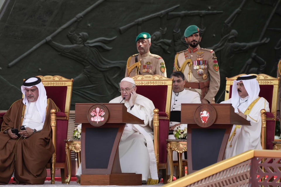 Pope Francis delivers his speech as Bahrain's Prince Salman bin Hamad Al Khalifa, left, and Bahrain's King Hamad bin Isa Al Khalifa listen during the closing session of the "Bahrain Forum for Dialogue: East and west for Human Coexistence", at the Al-Fida square at the Sakhir Royal palace, Bahrain, Friday, Nov. 4, 2022. Pope Francis is making the November 3-6 visit to participate in a government-sponsored conference on East-West dialogue and to minister to Bahrain's tiny Catholic community, part of his effort to pursue dialogue with the Muslim world.(AP Photo/Alessandra Tarantino)