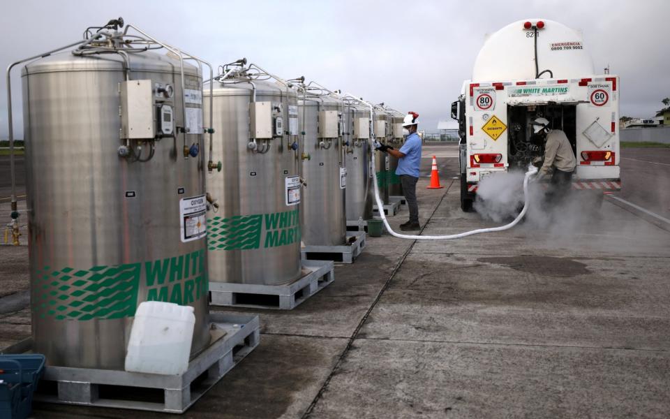 A truck is loaded with oxygen to fill the local hospitals, after it arrived on a Brazilian Air Force airplane in Manaus airport,  - Bruno Kelly/Reuters