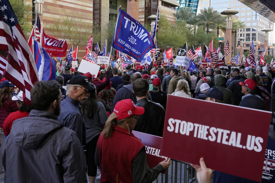 Supporters of President Donald Trump protest in front of a local hotel where Arizona Republicans have scheduled a meeting as a "fact-finding hearing" to discuss the election, featuring members of Trump's legal team and Arizona legislators, Monday, Nov. 30, 2020, in Phoenix. (AP Photo/Ross D. Franklin)