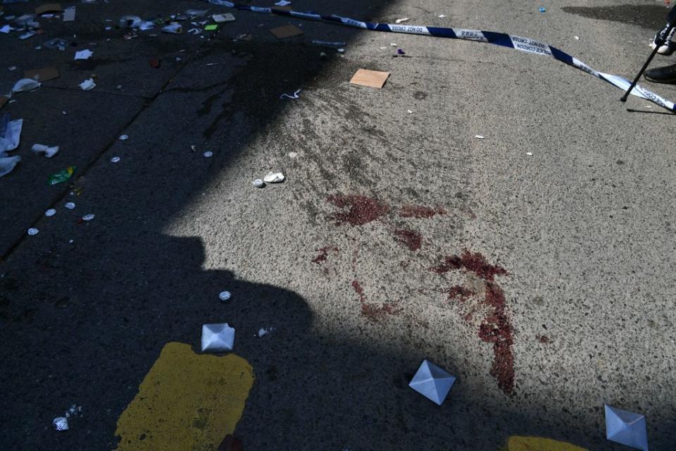 Blood stains can be seen on the road where the shooting happened. 