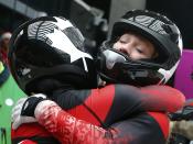 Canada's pilot Kaillie Humphries and Heather Moyse (R) celebrate after winning the women's bobsleigh event at the Sochi 2014 Winter Olympics February 19, 2014. REUTERS/Arnd Wiegmann (RUSSIA - Tags: OLYMPICS SPORT BOBSLEIGH TPX IMAGES OF THE DAY)