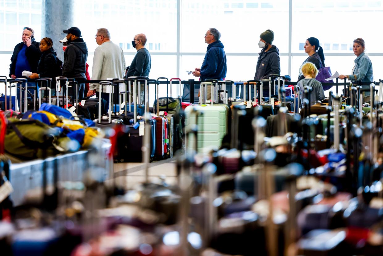 Travelers wait in line before they are allowed to search for their luggage in a baggage holding area for Southwest Airlines at Denver International Airport on December 28, 2022 in Denver, Colorado.