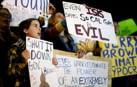 Madelyn Jones (L) holds a sign while rallying for the permanent shut down of the Aliso Canyon natural gas storage facility near the Porter Ranch neighborhood in Los Angeles, California February 19, 2016. REUTERS/Mario Anzuoni