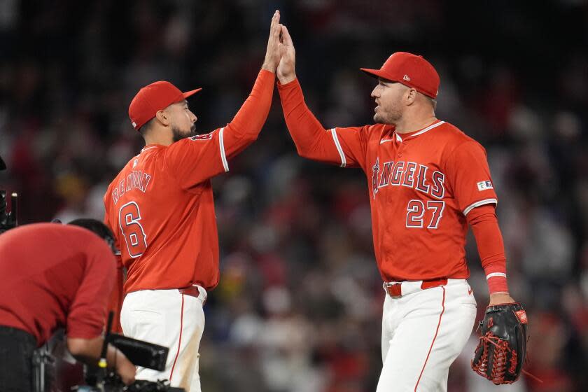 Anthony Rendon, left, and Mike Trout high-five each other after the Angels' win over the Red Sox