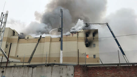 Firefighters extinguish a fire at a shopping mall in Kemerovo, Russia March 25, 2018. REUTERS/Dmitry Saturin