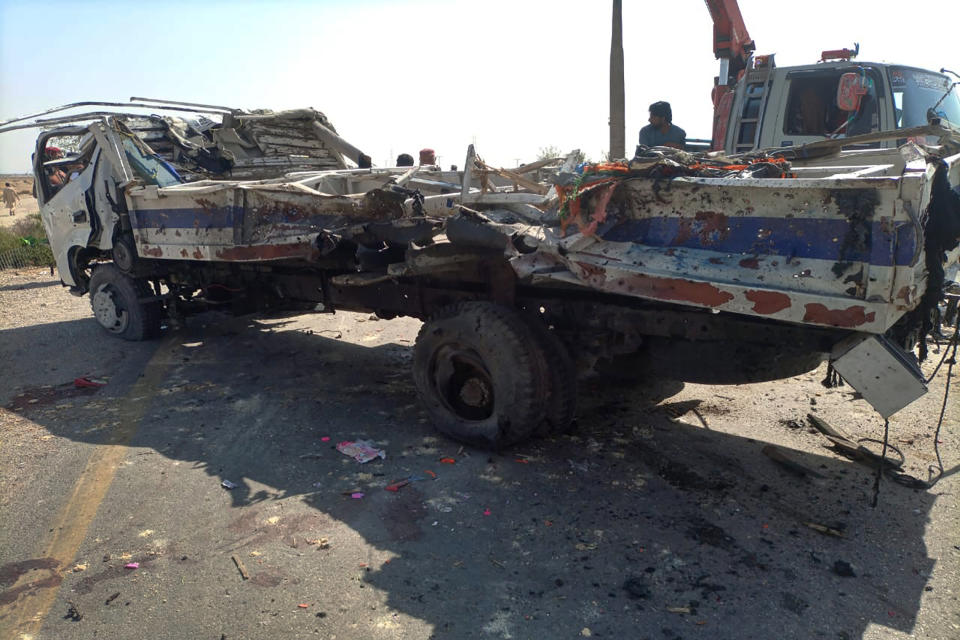 A damaged truck is removed from the site of a suicide bombing, in Sibi, a district in the Pakistan's Baluchistan province, Monday, March 6, 2023. A suicide bomber riding on a motorcycle rammed into a police truck in Pakistan's restive southwest, killing and wounding police officers in one of the deadliest attacks on security forces in recent months, authorities said. (AP Photo/Saeed-ud-Din)