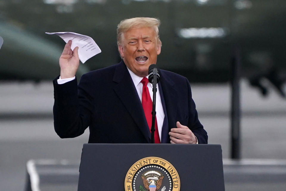 President Donald Trump holds up a paper he said had the recent poll numbers during a campaign rally at the Altoona-Blair County Airport in Martinsburg, Pa, Monday, Oct. 26, 2020. (Gene J. Puskar/AP)