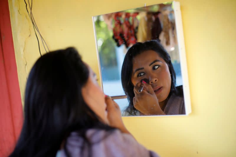 Irisnaide Silva, 32, an Indigenous leader of one of two main indigenous groups in the Amazonian state of Roraima, puts on her makeup in the Raposa Serra do Sol reservation