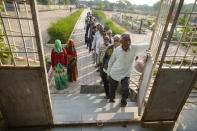 People stand in queue to cast their votes during the first phase of Gujarat state legislature elections in Limbadi, India, Thursday, Dec. 1, 2022. The voting in Prime Minister Narendra Modi’s home state’s local elections is seen as a barometer of his ruling Bharatiya Janata Party’s popularity ahead of a general election in 2024. (AP Photo/Ajit Solanki)