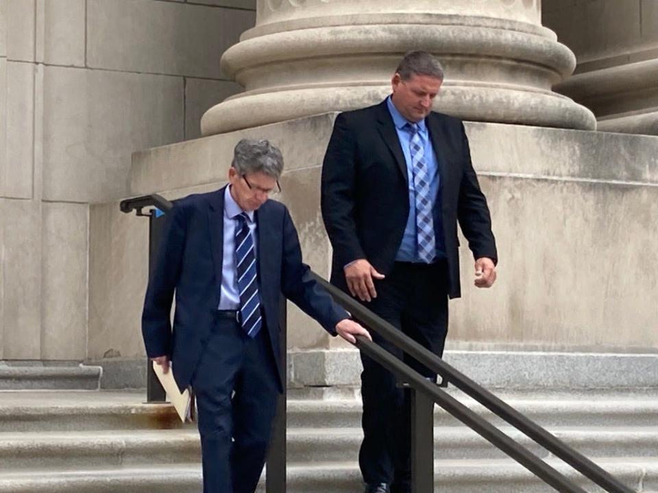 Indianapolis Metropolitan Police Sgt. Eric Huxley, right, walks out of the federal courthouse alongside his attorney John Kautzman after a sentencing hearing Sept. 8, 2023.