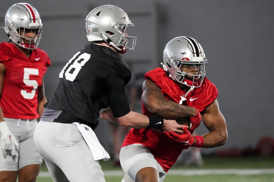 Mar 5, 2024; Columbus, OH, USA; Ohio State Buckeyes quarterback Will Howard (18) hands off to running back Quinshon Judkins (1) during the first spring practice at the Woody Hayes Athletic Center. Both players transferred to the Buckeyes this winter.