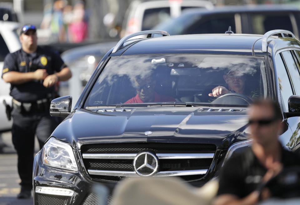 Tiger Woods, in passenger seat, leaves after withdrawing having played 13 holes in the final round of the Honda Classic golf tournament, Sunday, March 2, 2014 in Palm Beach Gardens, Fla. This is the second straight year the No. 1 player in the world didn't finish the Honda Classic. A year ago, it was Rory McIlroy who walked off the course in the middle of the second round. (AP Photo/Wilfredo Lee)