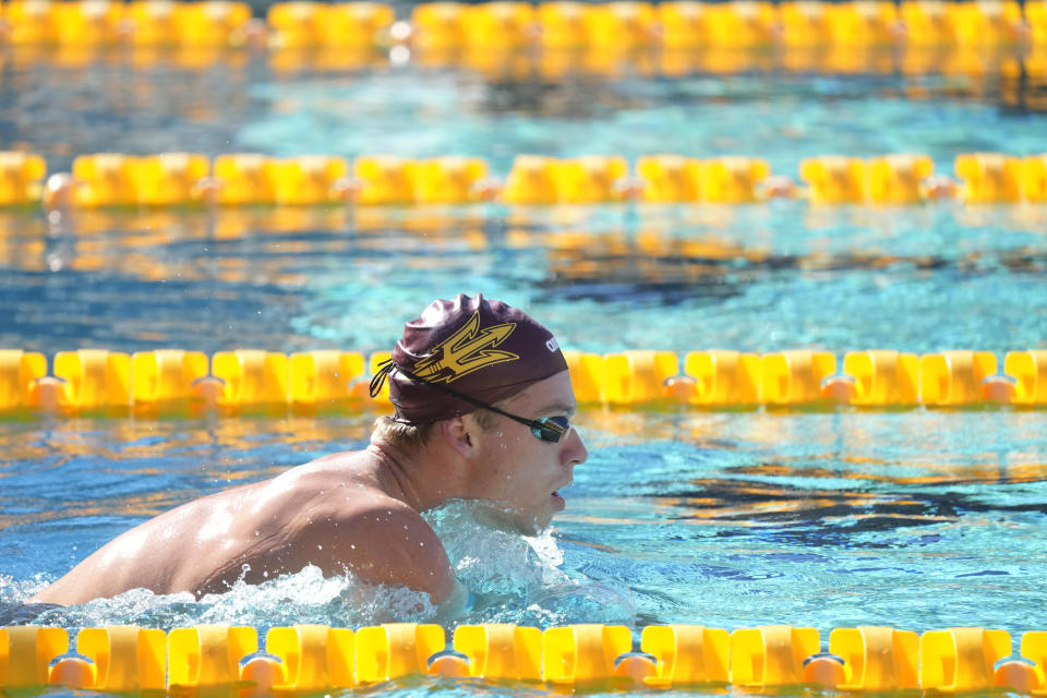 French Olympic swimmer Leon Marchand trains with his Arizona State University teammates, Tuesday, Feb. 13, 2024, in Tempe, Ariz. With family and friends — an entire nation — watching, the individual medley specialist is poised to be one of the premier faces of these Olympics. (AP Photo/Ross D. Franklin)