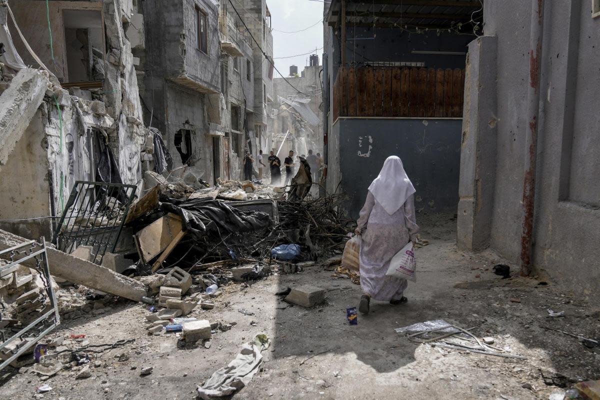 Palestinians inspect the destruction following an Israeli military raid in Nur Shams refugee camp, near the West Bank town of Tulkarem <i>(Image: AP Photo/Majdi Mohammed)</i>