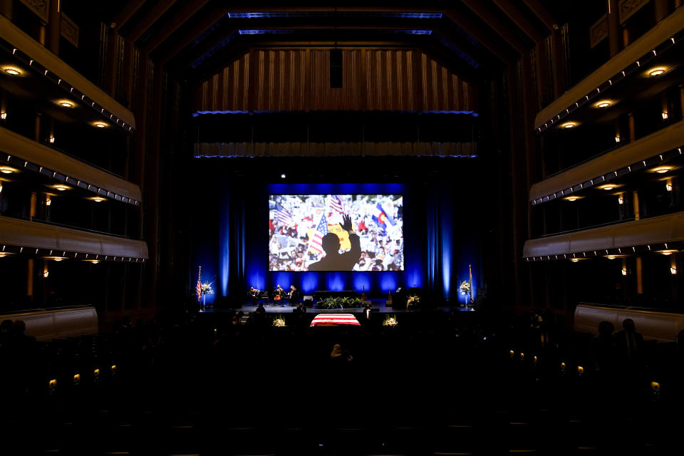 An image of former Senate Majority Leader Harry Reid campaigning is displayed above his flag-draped casked after a memorial service for Reid at the Smith Center in Las Vegas, Saturday, Jan. 8, 2022. (AP Photo/John Locher)