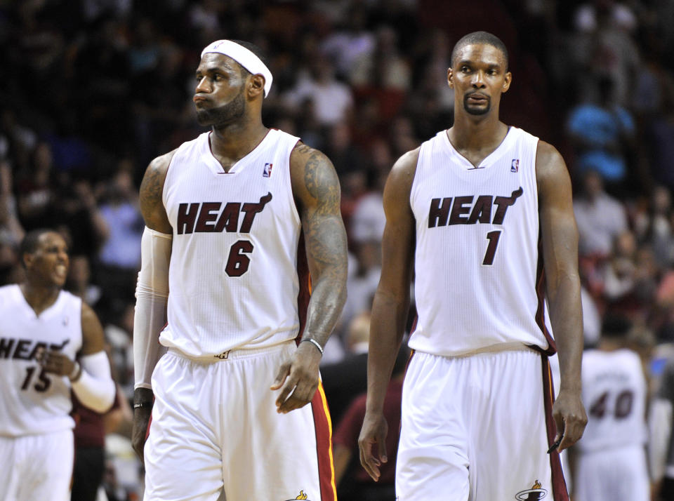 Miami Heat forward LeBron James (left) and center Chris Bosh (right) both react during the second half against the Minnesota Timberwolves at American Airlines Arena.