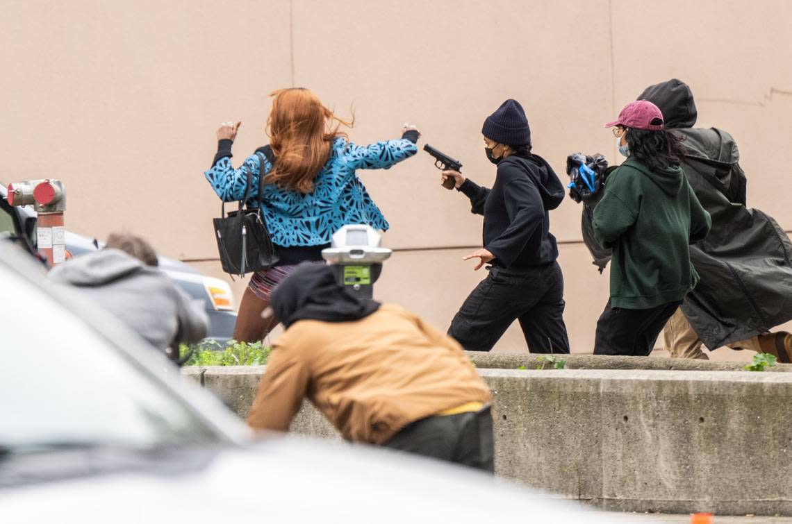 Actors take part in the production of a Warner Bros. Studios on Tuesday, Feb. 6, 2024 in Sacramento. The scene recorded included actors running with weapons on 6th Street between I and J Streets.