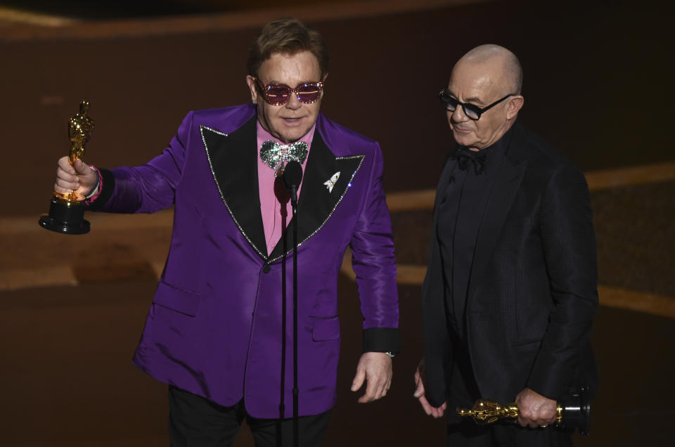 Elton John, left, and Bernie Taupin accept the award for best original song for "(I'm Gonna) Love Me Again" from "Rocketman" at the Oscars on Sunday, Feb. 9, 2020, at the Dolby Theatre in Los Angeles. (AP Photo/Chris Pizzello)