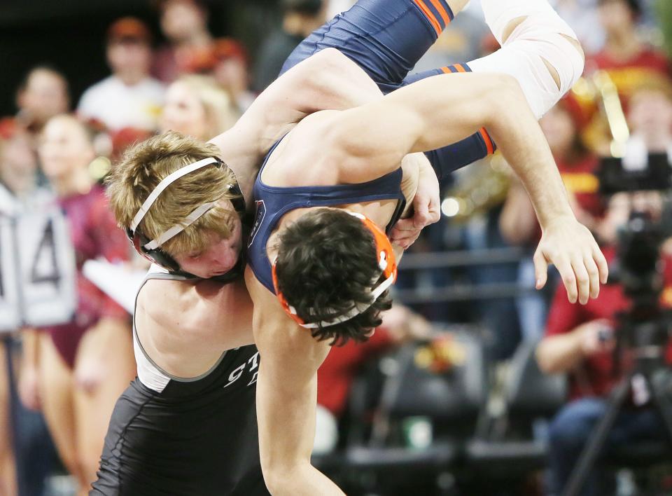 Iowa State Cyclones Casey Swiderski takes down Illinois Fighting Illini's Danny Pucino during 141-pound wrestling in an NCAA dual meet at Hilton Coliseum Sunday, Feb. 12, 2023, in Ames, Iowa.