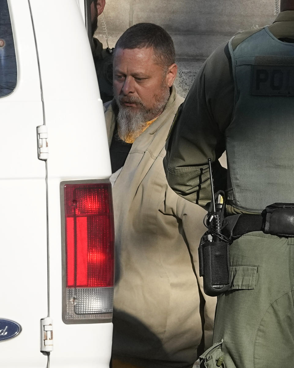 Officers escort Richard Matthew Allen, out of the Carroll County courthouse following a hearing, Tuesday, Nov. 22, 2022, in Delphi, Ind. Allen was charged last month with two counts of murder in the killings of Liberty German, 14, and Abigail Williams, 13. (AP Photo/Darron Cummings)