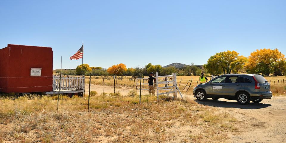 A vehicle from the Office of the Medical Investigator enters the front gate leading to the Bonanza Creek Ranch on October 22, 2021 in Santa Fe, New Mexico.