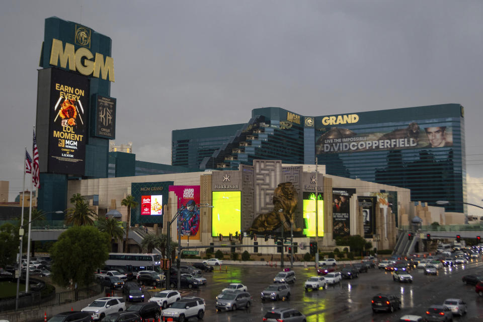 Cars pass the MGM Grand hotel-casino during a rain storm on Wednesday, Sept. 20, 2023, in Las Vegas. MGM Resorts International says computers serving customers at its casino and hotel properties have been restored across the U.S. That’s 10 days after a cyberattack led it to shut down digital systems. (AP Photo/ Ty ONeil)