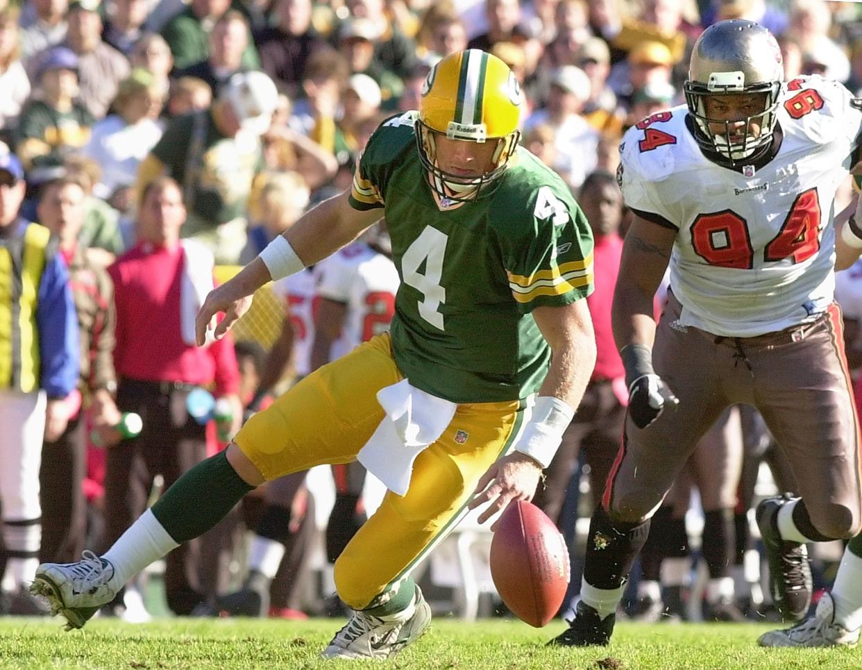 Green Bay Packers quarterback Brett Favre (4) and Tampa Bay Buccaneers defensive end Steve White (94) go after a fumble in the first half Sunday, Nov. 4, 2001, in Green Bay, Wis. Favre recovered the ball. (AP Photo/Mike Roemer)