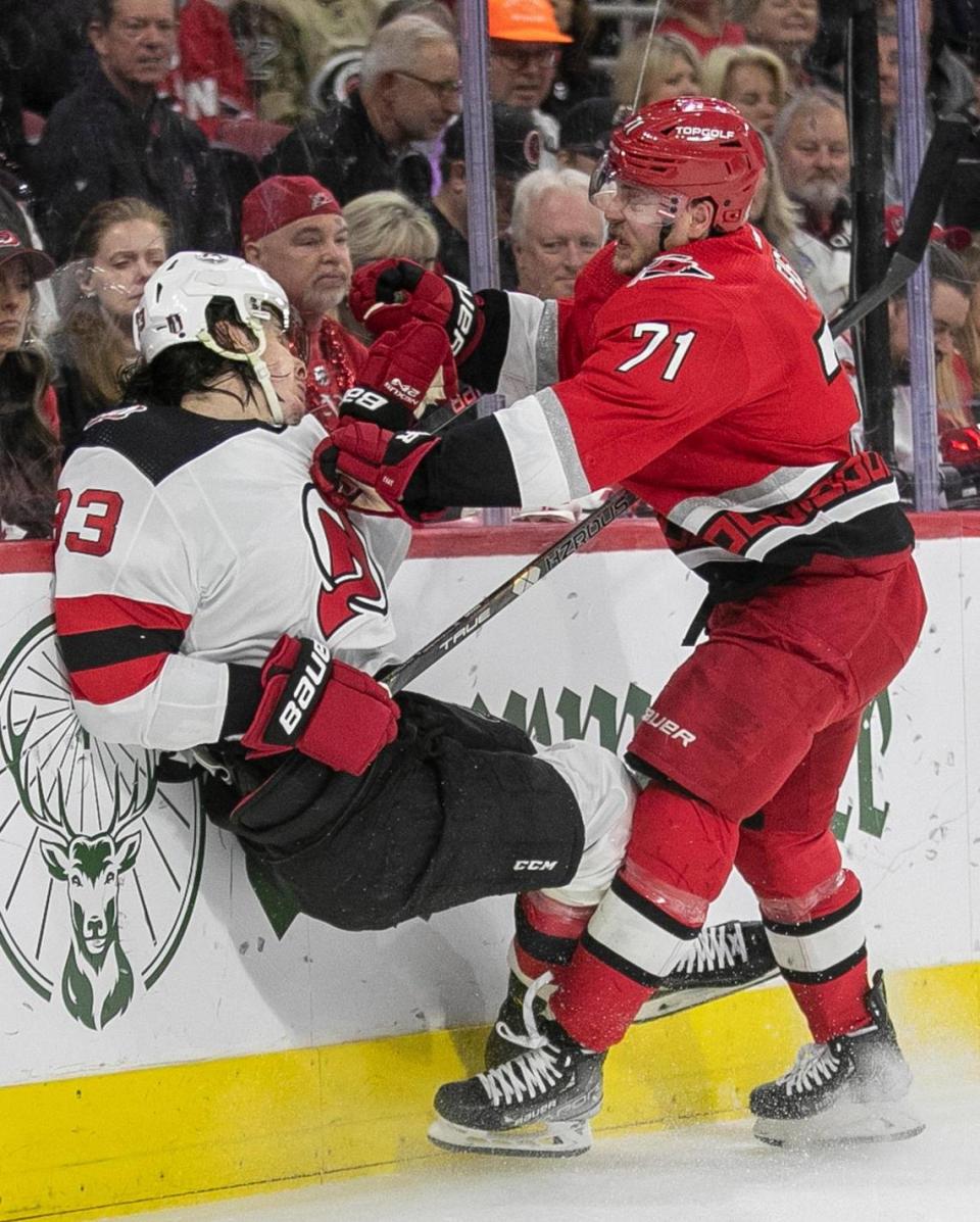 The Carolina Hurricanes Jesper Fast (71) checks the New Jersey Devils Ryan Graves (33) into the boards in the first period during Game 2 of their second round Stanley Cup playoff series on Friday, May 5, 2023 at PNC Arena in Raleigh, N.C.