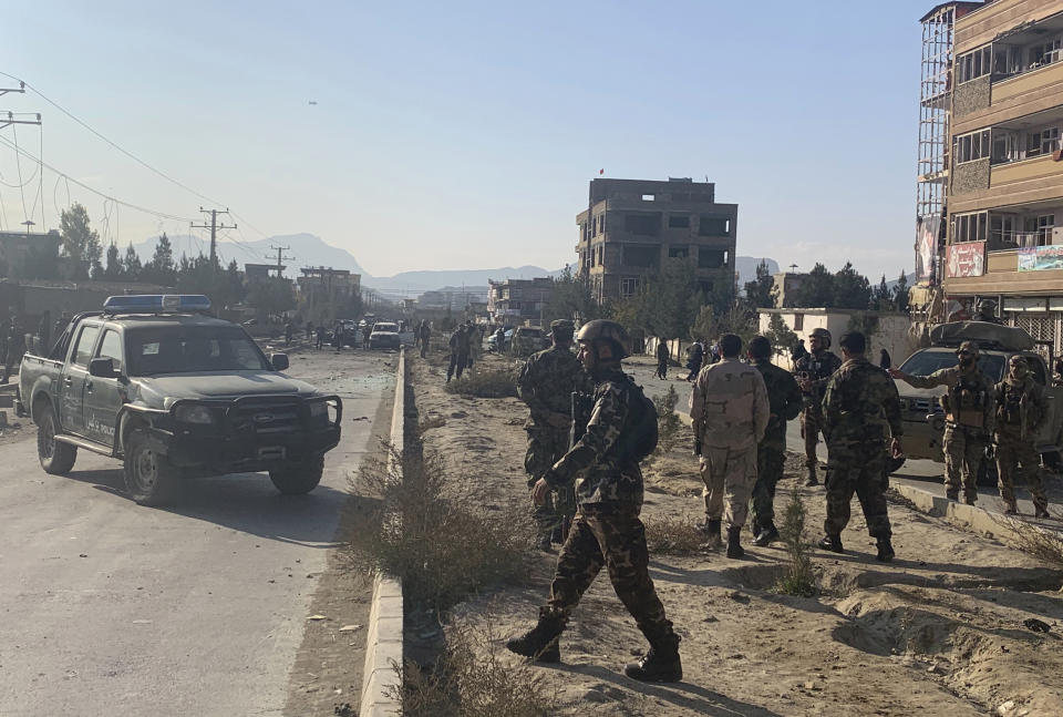 Afghan security personnel gather at the site of an explosion in Kabul, Afghanistan, Wednesday, Nov. 13, 2019. An explosion has rocked the Afghan capital of Kabul as early morning commuters were on the street heading to work. (AP Photo/Rahmat Gul)