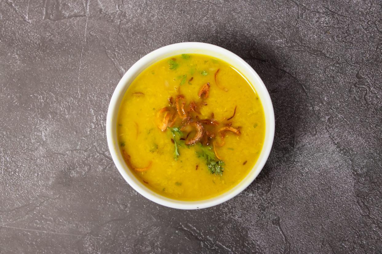 Spicy masoor dal or ghono dal with fried onion served in dish isolated on background top view of bangladesh food