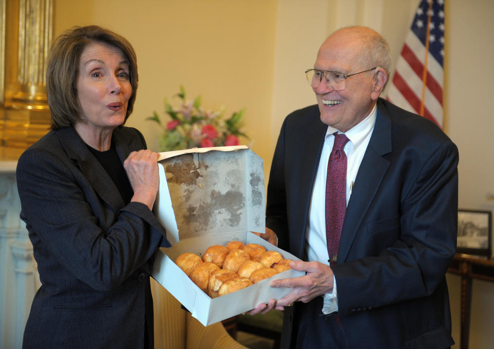 Dingell gives House Speaker Nancy Pelosi (D-Calif.) a box of paczki, a traditional pastry commonly eaten on Fat Tuesday and brought from Detroit's&nbsp;Chene Modern Bakery, on Feb. 5, 2007.